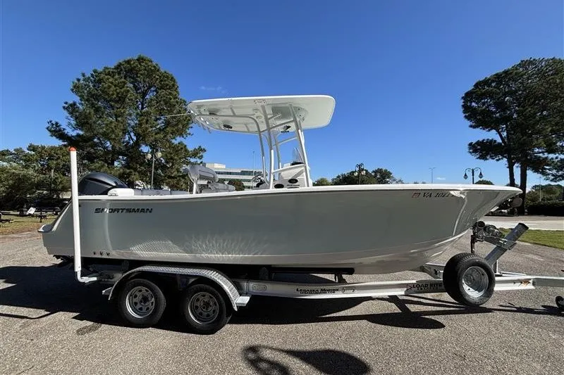 The Image of 2014 Sportsman Heritage 231 Center Console boat on trailer, parked outdoors. - 0