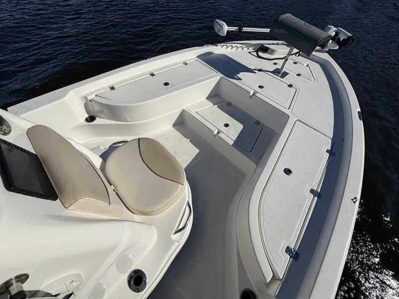 Slide: The Image of The image shows the deck of a 2022 NauticStar 215 XTS boat with seating and storage. - 13