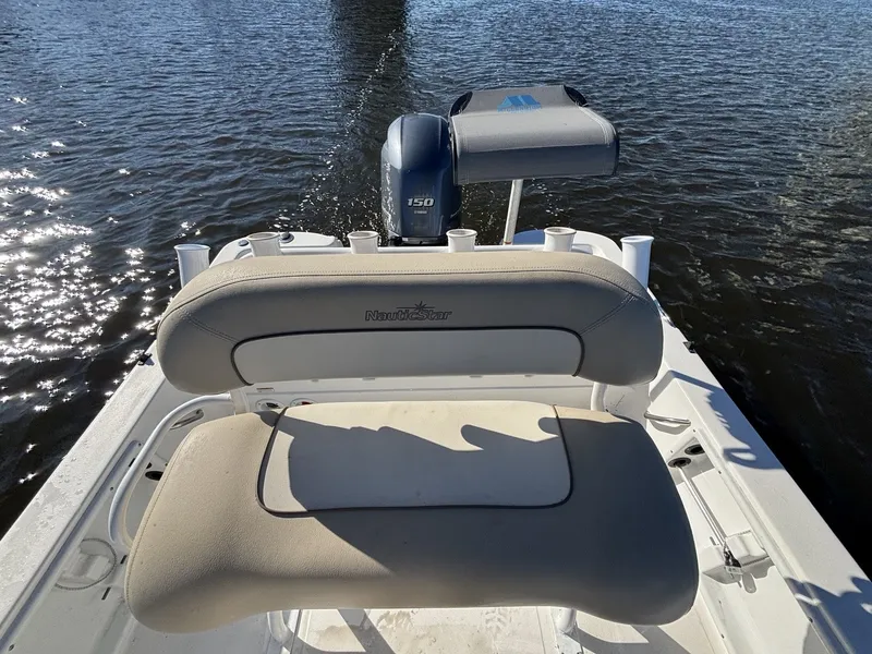 Slide: The Image of The image shows the stern of a NauticStar 215 XTS boat on the water. - 17