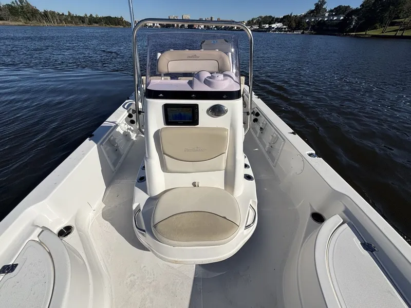 Slide: The Image of The image shows a 2022 NauticStar 215 XTS boat on calm waters. - 9