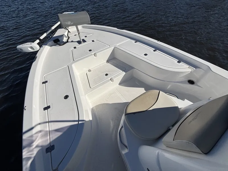Slide: The Image of The image shows the deck of a 2022 NauticStar 215 XTS boat on the water. - 14