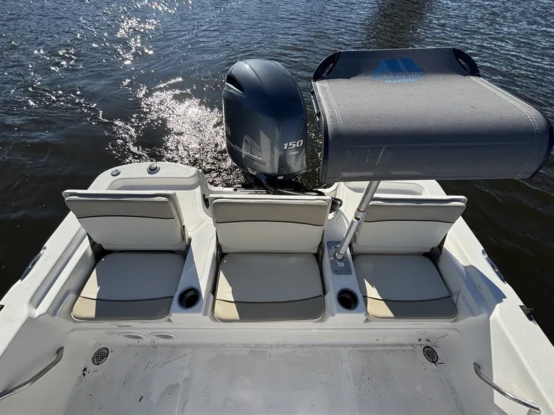 Slide: The Image of The image shows the stern of a 2022 NauticStar 215 XTS boat with three seats and an outboard motor. - 19