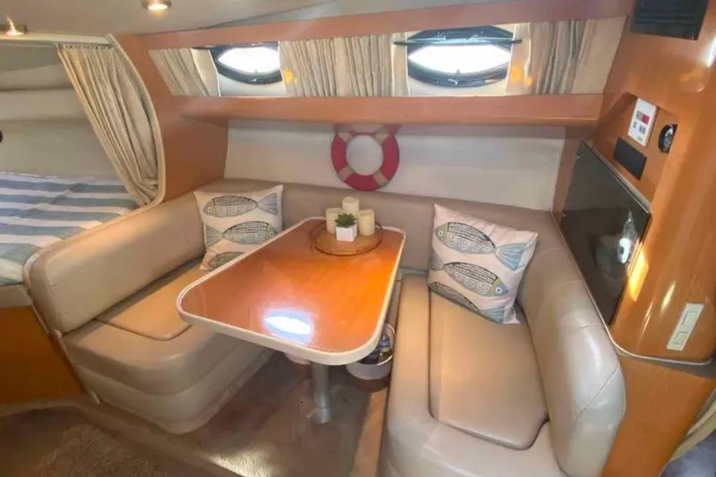 Slide: The Image of Interior of 2000 Regal Commodore 2960 boat with cozy seating and decorative pillows. - 2
