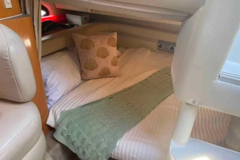 Slide: The Image of Cozy cabin interior of 2000 Regal Commodore 2960 with bed and decorative pillow. - 3