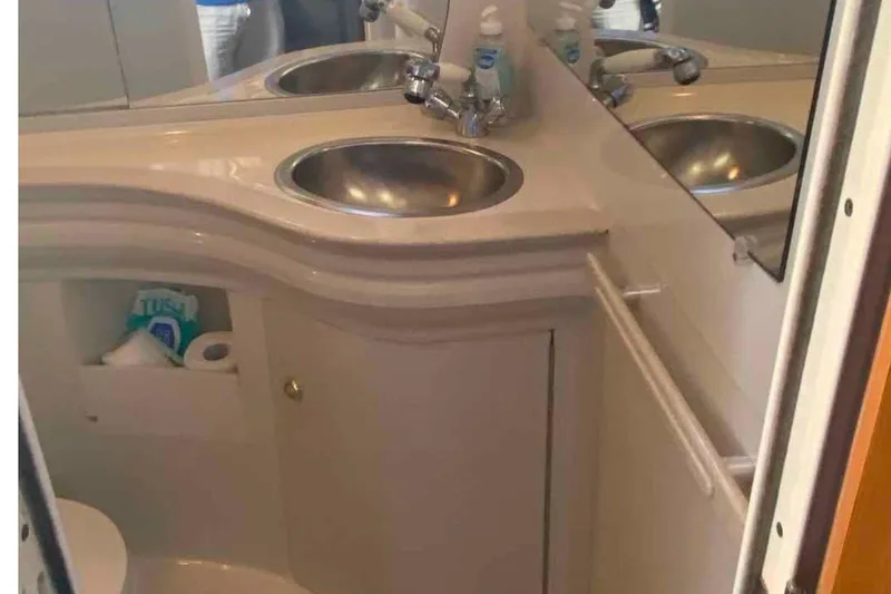 Slide: The Image of Bathroom interior of 2000 Regal Commodore 2960 yacht with dual sinks and storage. - 6