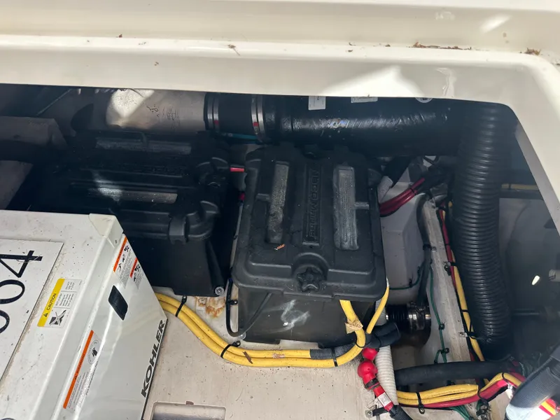 Slide: The Image of View of a 2012 Meridian 341 Sedan engine compartment with batteries and wiring. - 35