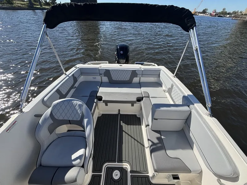 Slide: The Image of The image shows the cockpit of a 2025 Bayliner VR4 Bowrider OB with gray upholstery. - 16