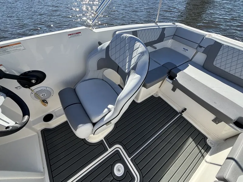 Slide: The Image of The image shows the cockpit of a 2025 Bayliner VR4 Bowrider OB with gray upholstery. - 14