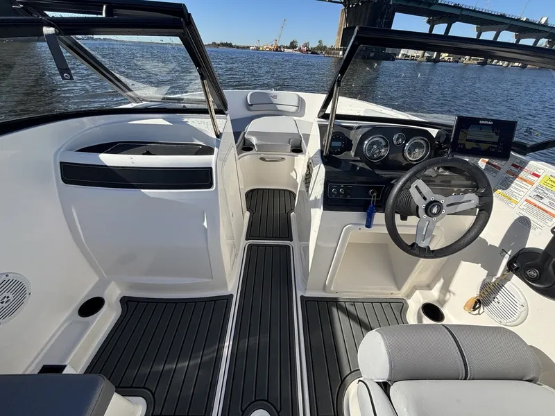 Slide: The Image of The image shows the cockpit of a 2025 Bayliner VR4 Bowrider OB with a modern design. - 12
