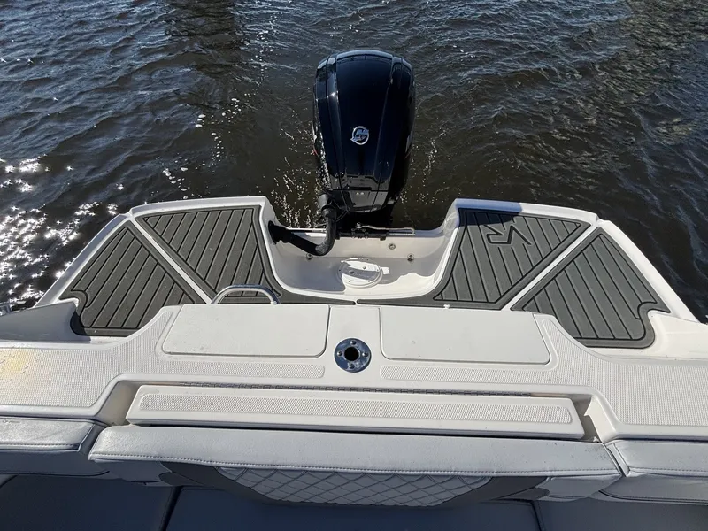 Slide: The Image of The image shows the stern of a 2025 Bayliner VR4 Bowrider OB with an outboard motor. - 18