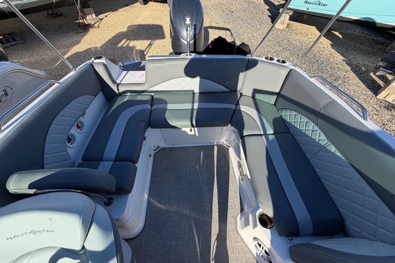 Slide: The Image of 2024 NauticStar 223 DC Deck boat interior with gray seating and modern design. - 10
