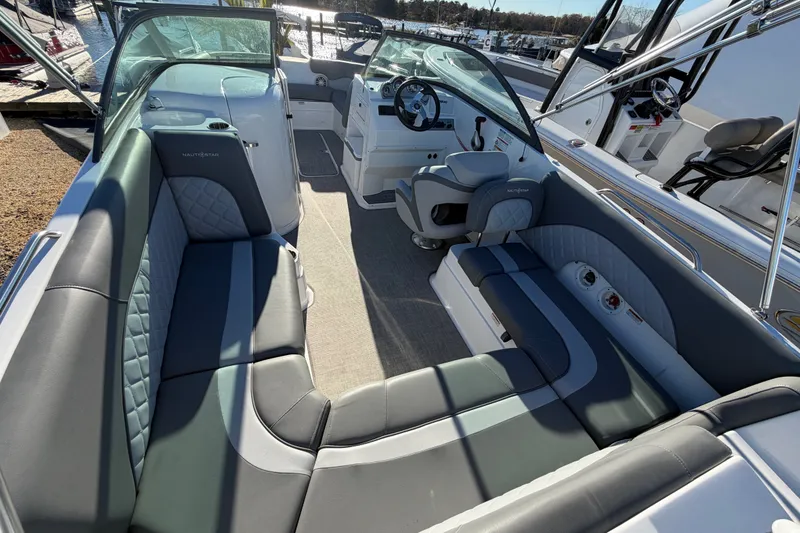 Slide: The Image of 2024 NauticStar 223 DC Deck boat interior with luxurious seating and modern dashboard. - 7