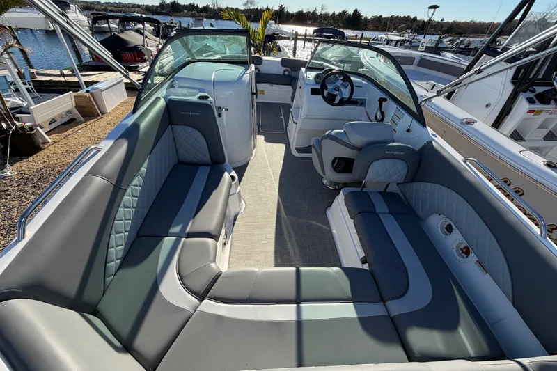 Slide: The Image of 2024 NauticStar 223 DC Deck boat interior with luxurious seating and modern helm. - 8