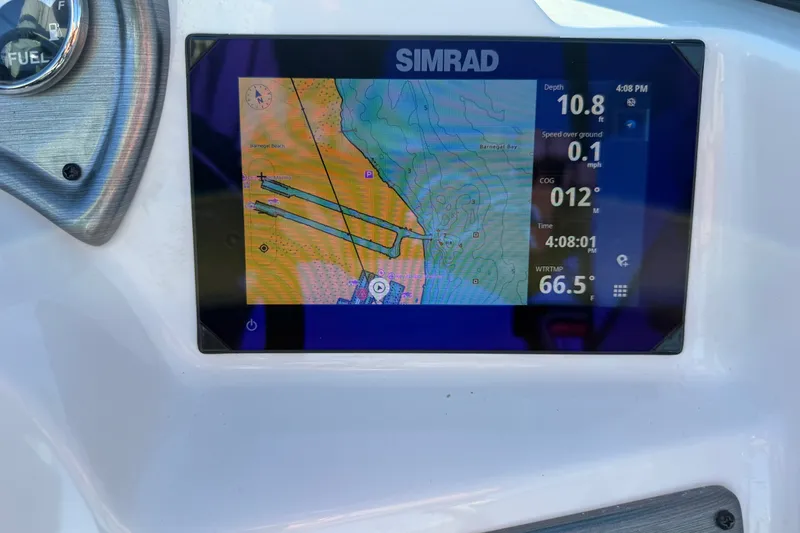 Slide: The Image of Simrad navigation display on 2024 NauticStar 223 DC Deck boat, showing map and data. - 24