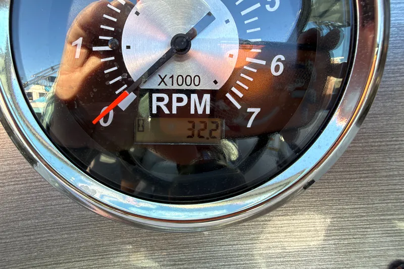 Slide: The Image of Close-up of a 2024 NauticStar 223 DC Deck boat tachometer showing 3,220 RPM. - 23