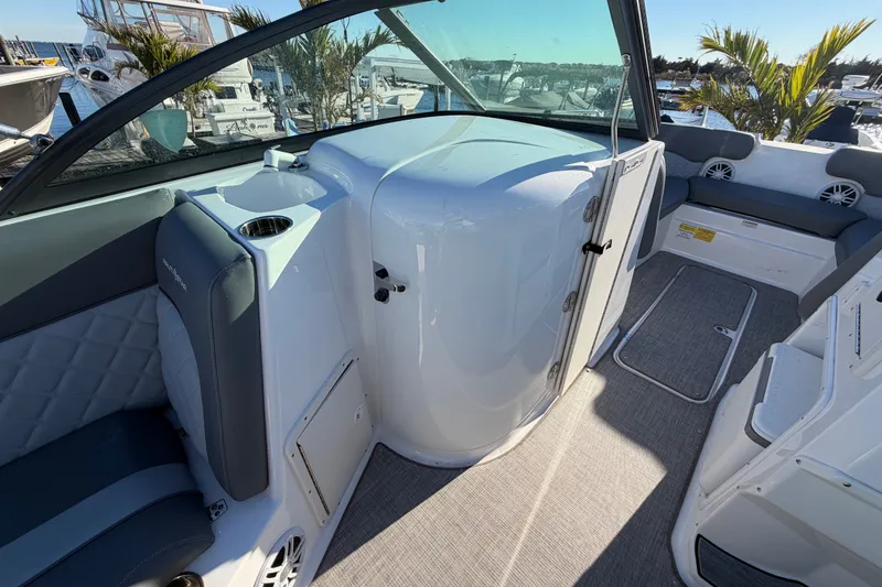 Slide: The Image of 2024 NauticStar 223 DC Deck boat interior with seating and storage compartments. - 14