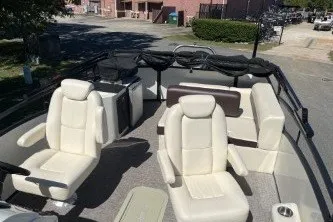 Slide: The Image of 2024 Palm Beach 23 HPT boat interior with cream seats and spacious layout. - 7
