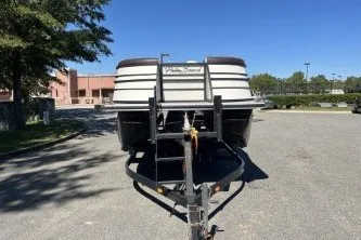 Slide: The Image of 2024 Palm Beach 23 HPT boat on trailer in parking lot, sunny day. - 2