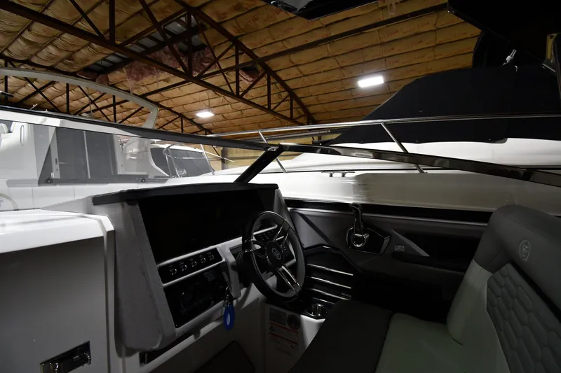 Slide: The Image of Interior view of 2024 Cobalt A29 boat cockpit with modern steering and controls. - 9