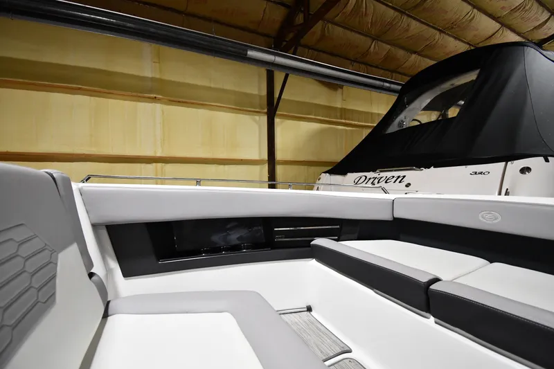 Slide: The Image of 2024 Cobalt A29 boat interior with sleek seating in a storage facility. - 24