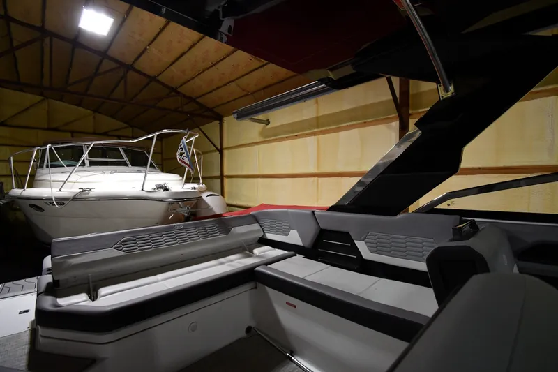 Slide: The Image of 2024 Cobalt A29 boat interior in a dimly lit garage. - 17