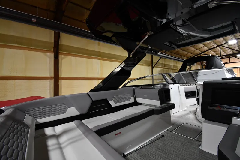 Slide: The Image of 2024 Cobalt A29 boat interior with modern seating and sleek design in a showroom. - 16