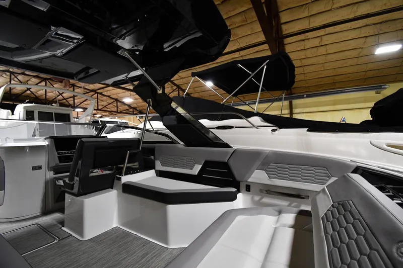 Slide: The Image of 2024 Cobalt A29 boat interior with modern seating and sleek design in a showroom. - 15