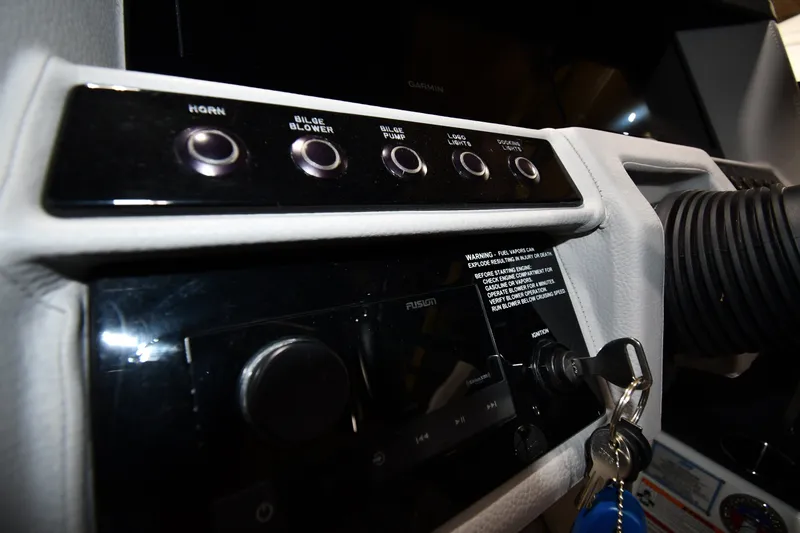 Slide: The Image of 2024 Cobalt A29 boat dashboard with control buttons and ignition keys. - 12