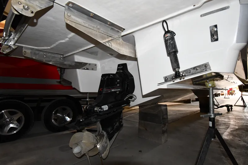 Slide: The Image of 2024 Cobalt A29 boat underside with propeller and trailer in a garage. - 36