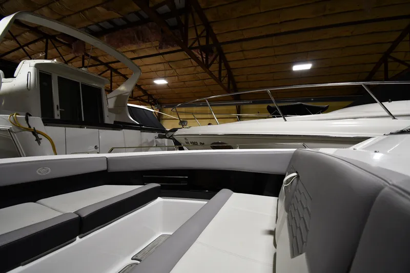 Slide: The Image of 2024 Cobalt A29 boat interior in a dimly lit storage facility. - 23
