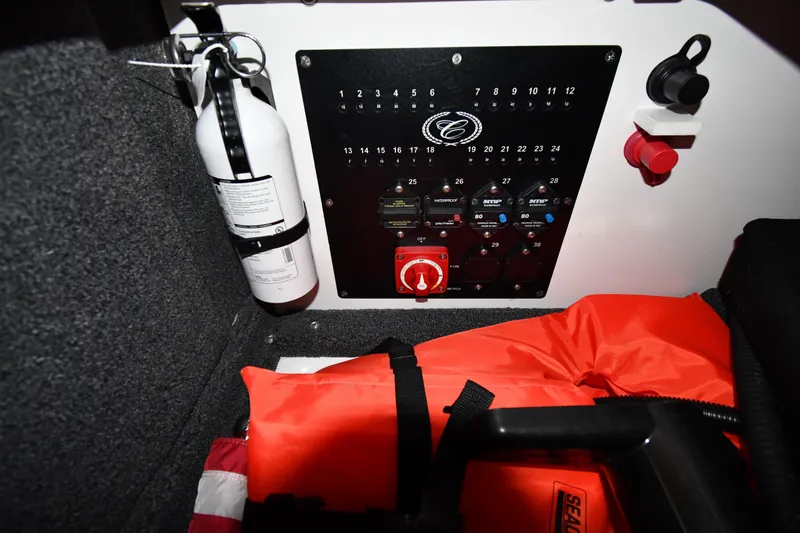 Slide: The Image of 2024 Cobalt A29 boat control panel with fire extinguisher and safety equipment. - 21