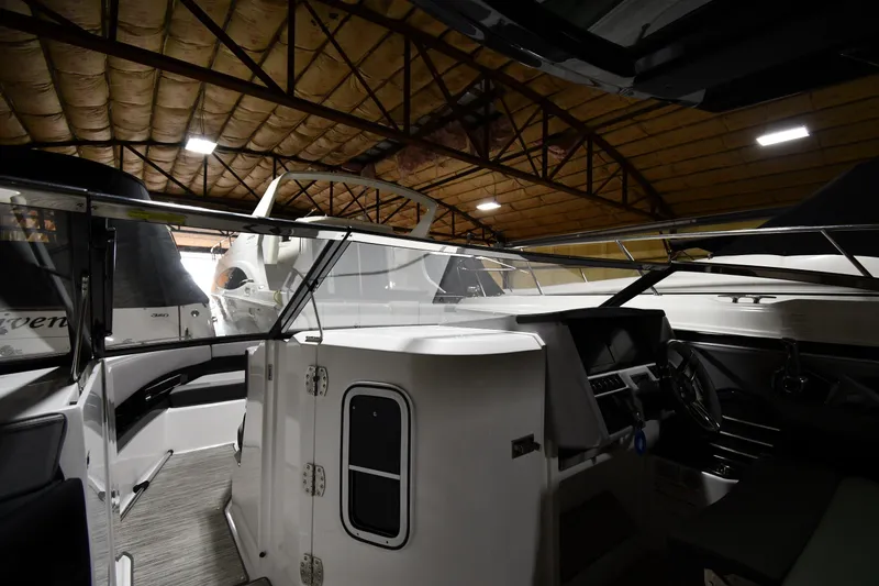 Slide: The Image of 2024 Cobalt A29 boat interior in a dimly lit storage facility. - 8
