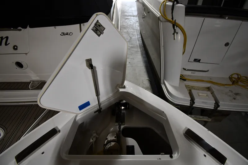 Slide: The Image of Open storage compartment on a 2024 Cobalt A29 boat, docked indoors. - 5