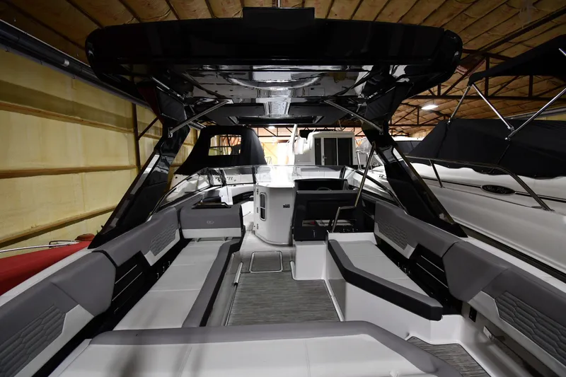 Slide: The Image of 2024 Cobalt A29 boat interior with sleek seating and modern design in a showroom. - 3