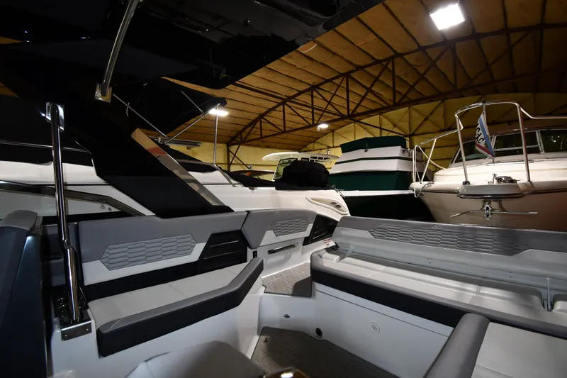 Slide: The Image of 2024 Cobalt A29 boat interior in a showroom, featuring sleek seating and modern design. - 18