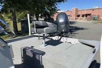 Slide: The Image of 2015 G3 1756 CC boat with outboard motor in a sunny outdoor setting. - 8
