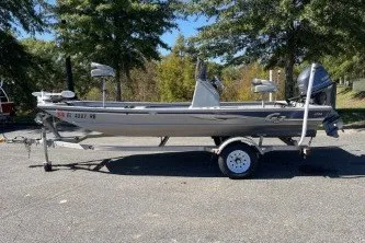 The Image of 2015 G3 1756 CC boat on trailer, parked outdoors with trees in background. - 0