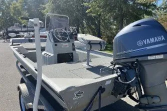 Slide: The Image of 2015 G3 1756 CC boat with Yamaha outboard motor, parked outdoors. - 6