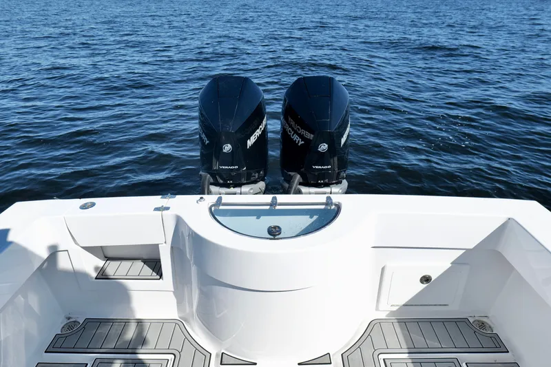 Slide: The Image of 2024 Onslow Bay 27 Offshore Edition boat with twin Mercury Verado engines on open water. - 20