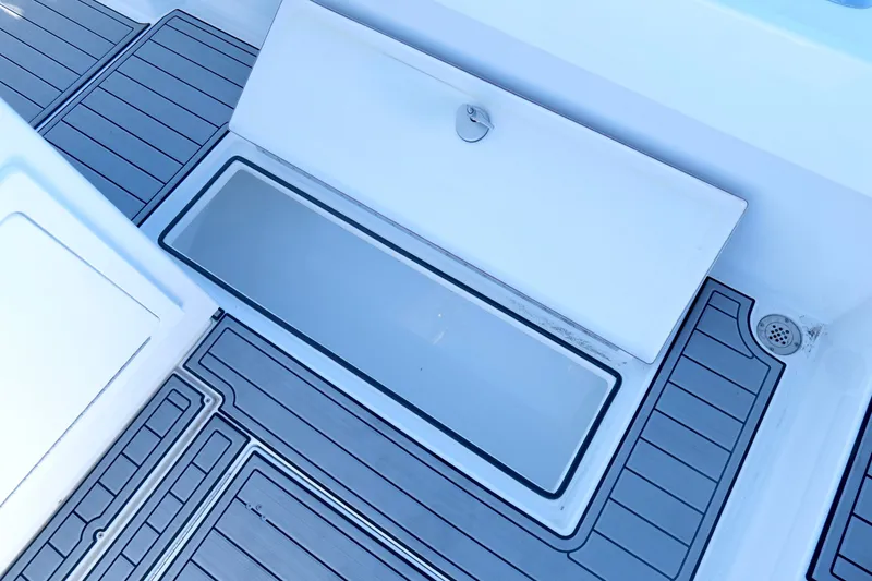 Slide: The Image of 2024 Onslow Bay 27 Offshore Edition boat deck with open storage compartment. - 31