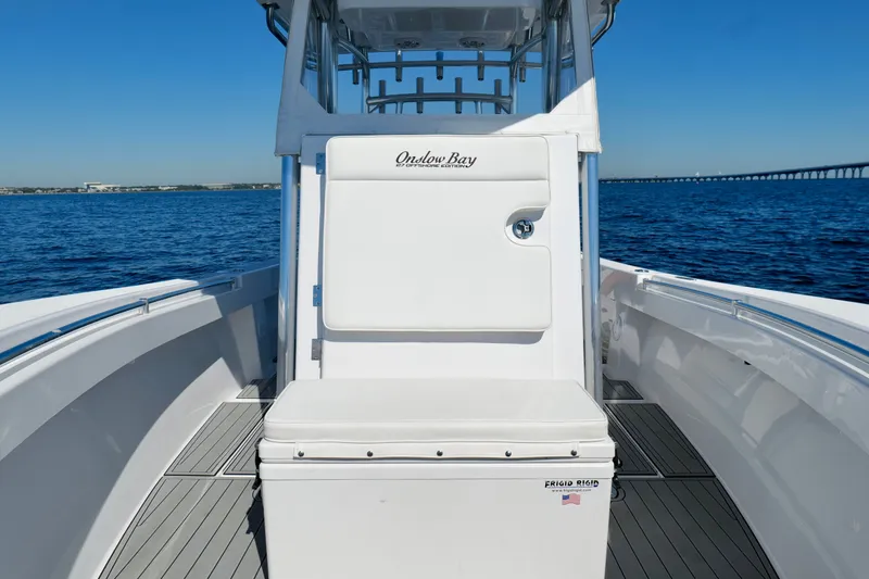 Slide: The Image of 2024 Onslow Bay 27 Offshore Edition boat on open water, showcasing sleek design and seating. - 38
