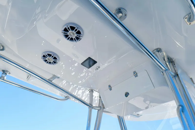 Slide: The Image of 2024 Onslow Bay 27 Offshore Edition boat interior with speakers and storage compartment. - 15