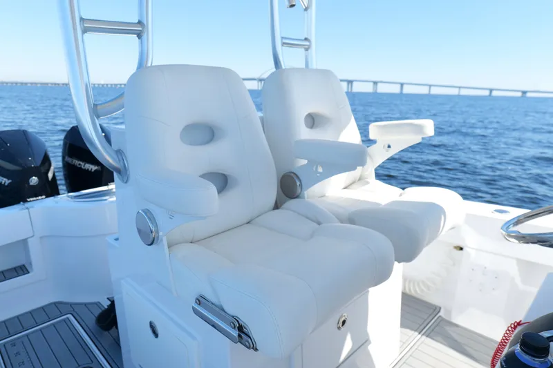 Slide: The Image of 2024 Onslow Bay 27 Offshore Edition boat with luxurious white seating on open water. - 17