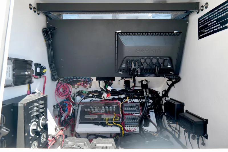 Slide: The Image of 2024 Onslow Bay 27 Offshore Edition electronics compartment with Garmin system and wiring. - 39