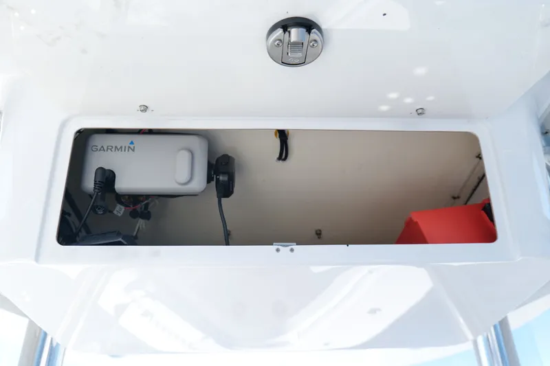Slide: The Image of 2024 Onslow Bay 27 Offshore Edition electronics compartment with Garmin device. - 16