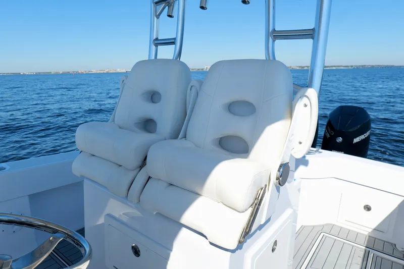 Slide: The Image of 2024 Onslow Bay 27 Offshore Edition boat with white cushioned seats on open water. - 18