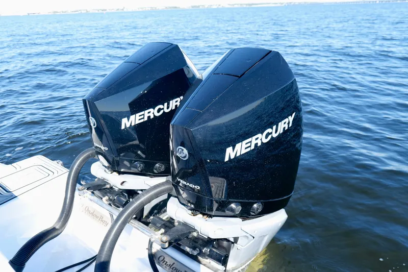 Slide: The Image of Twin Mercury outboard engines on a 2024 Onslow Bay 27 Offshore Edition boat. - 29