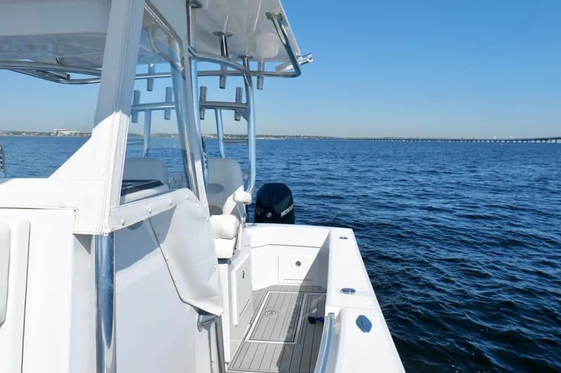 Slide: The Image of 2024 Onslow Bay 27 Offshore Edition boat on open water under clear blue sky. - 32
