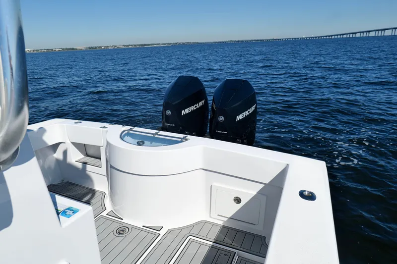 Slide: The Image of 2024 Onslow Bay 27 Offshore Edition boat with twin Mercury engines on open water. - 21