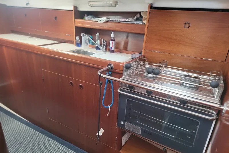 Slide: The Image of Interior of 2001 Beneteau Oceanis Clipper 36 CC yacht kitchen with stove and sink. - 3
